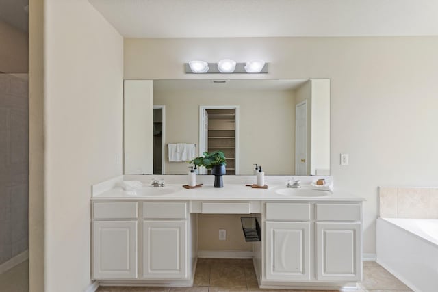 full bath with a sink, a garden tub, double vanity, and tile patterned floors