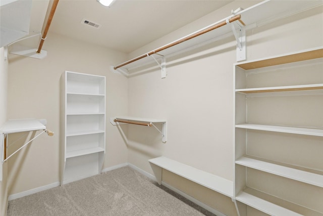 spacious closet with visible vents and carpet floors