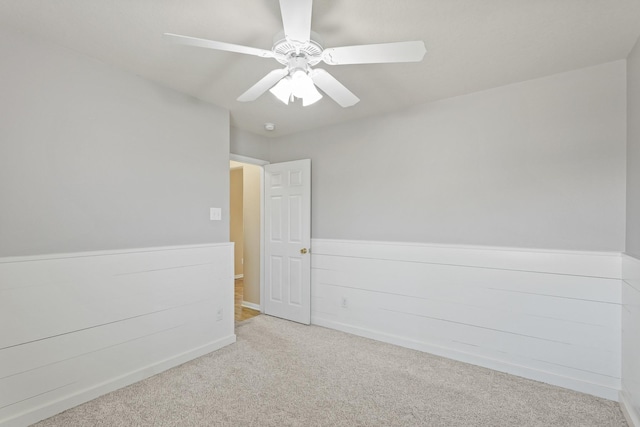 empty room with carpet flooring and ceiling fan