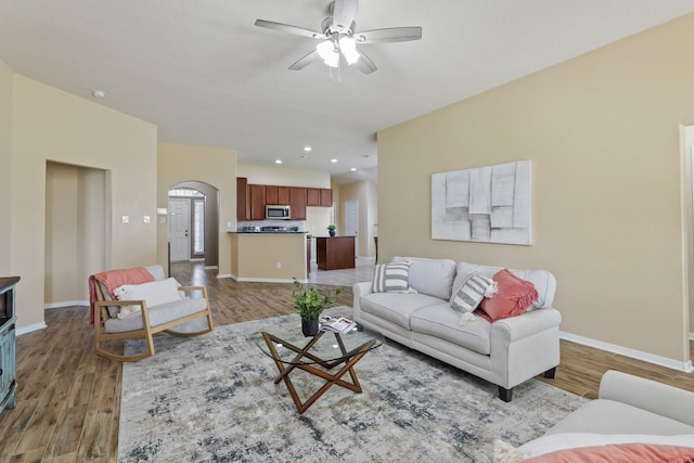 living area featuring recessed lighting, baseboards, light wood-type flooring, and a ceiling fan