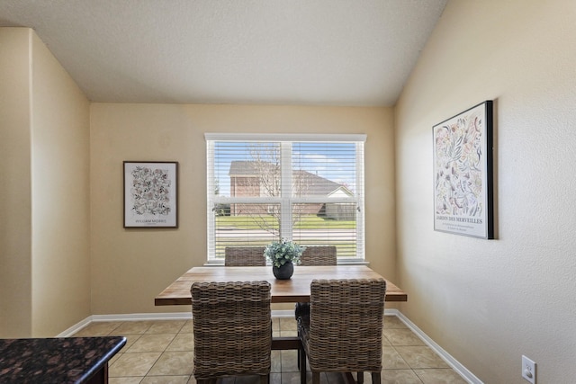 dining area with light tile patterned floors and baseboards