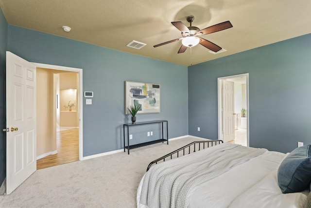 carpeted bedroom featuring baseboards, visible vents, and ceiling fan