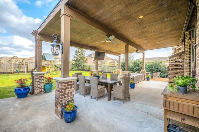 view of patio / terrace with outdoor dining area, a fenced backyard, and a playground