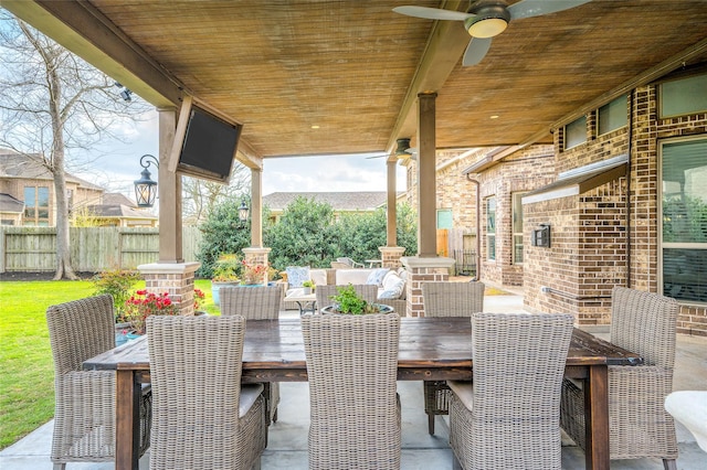 view of patio / terrace featuring ceiling fan, outdoor dining space, and fence