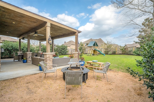 view of patio / terrace featuring a ceiling fan, an outdoor living space, a playground, and a fenced backyard