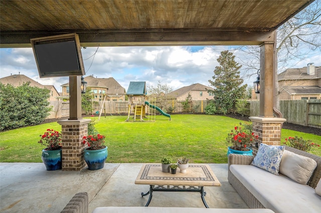 view of patio with outdoor lounge area, a playground, and a fenced backyard