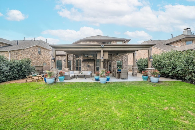 rear view of property with an outdoor living space, a lawn, a patio, and fence