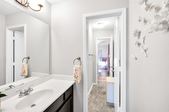 bathroom with baseboards and vanity