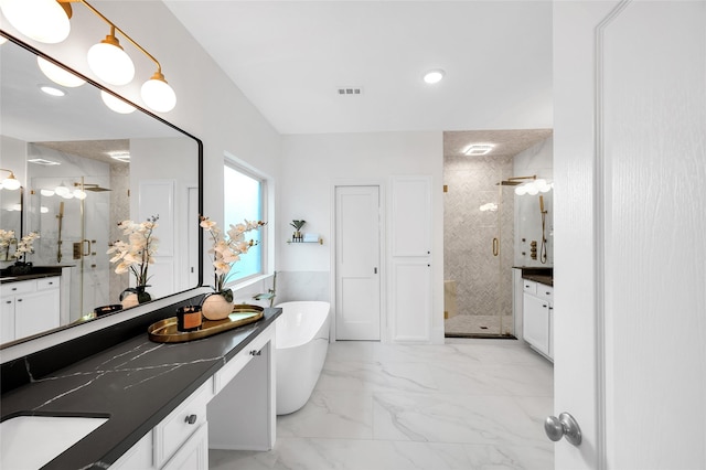 bathroom with visible vents, marble finish floor, a stall shower, and a freestanding bath