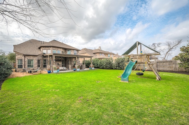 back of property featuring a patio, a playground, a yard, and a fenced backyard