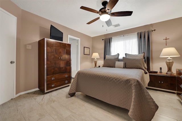 bedroom featuring visible vents, baseboards, and a ceiling fan