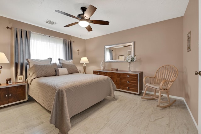 bedroom with visible vents, baseboards, and a ceiling fan