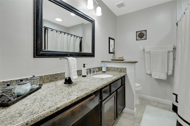 bathroom featuring vanity, visible vents, baseboards, tile patterned flooring, and toilet