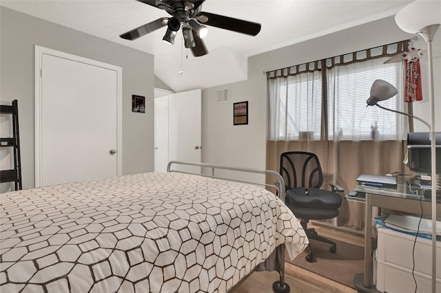 bedroom featuring lofted ceiling, visible vents, and ceiling fan