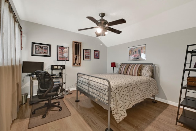 bedroom featuring lofted ceiling, baseboards, light wood finished floors, and ceiling fan