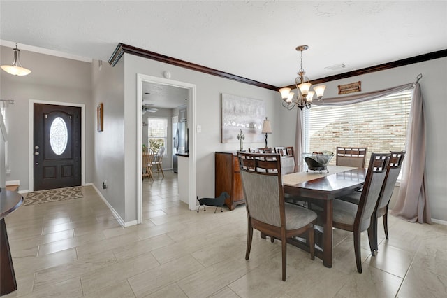 dining space featuring visible vents, baseboards, a chandelier, ornamental molding, and a textured ceiling