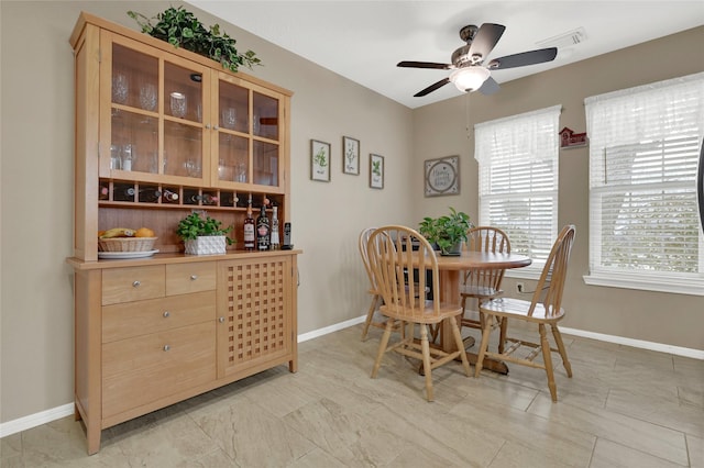 dining area featuring visible vents, a ceiling fan, and baseboards