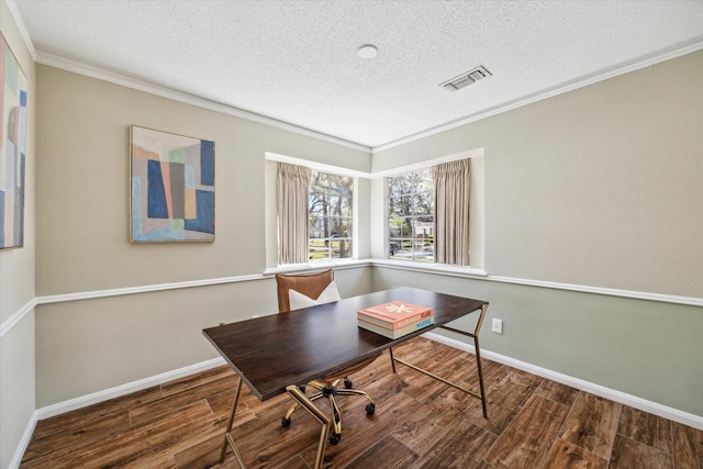 office featuring visible vents, a textured ceiling, wood finished floors, and crown molding