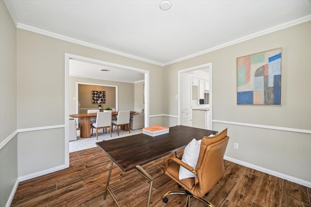 dining area featuring wood finished floors, baseboards, and ornamental molding