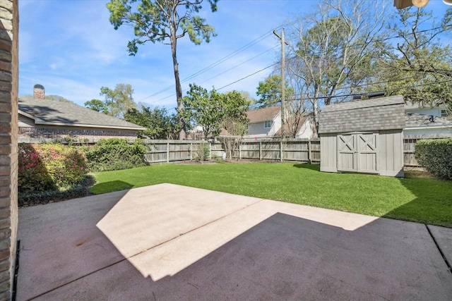 view of yard with a patio area, a storage shed, an outbuilding, and a fenced backyard