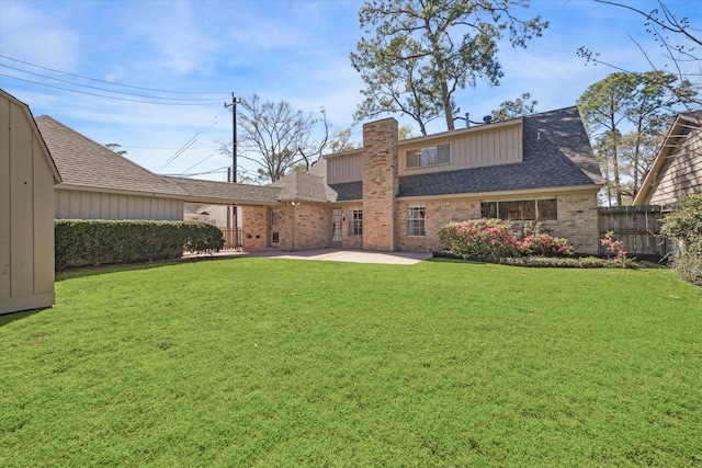 back of house featuring a patio, a yard, fence, and roof with shingles