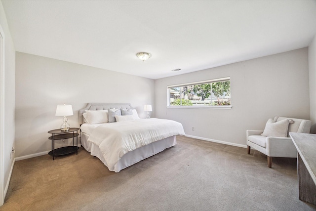 bedroom featuring light colored carpet, visible vents, and baseboards