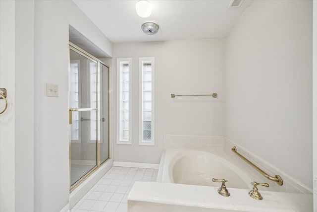 bathroom with a bath, tile patterned floors, a healthy amount of sunlight, and a stall shower