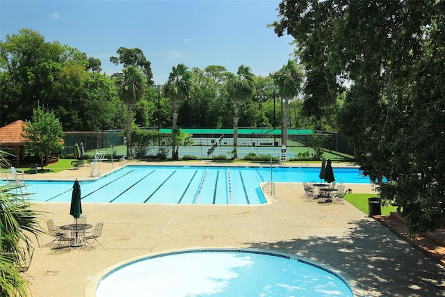 pool featuring a patio and fence