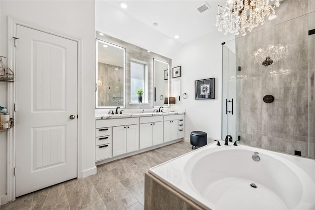 bathroom featuring visible vents, a garden tub, a stall shower, a sink, and an inviting chandelier