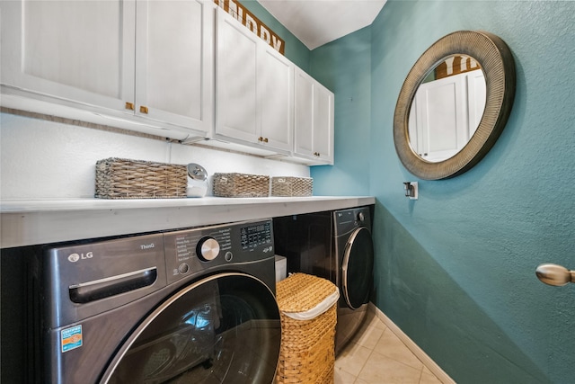 laundry room with tile patterned floors, baseboards, cabinet space, and washing machine and dryer