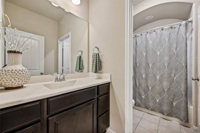 full bath featuring tile patterned flooring, toilet, vanity, and shower / bath combo