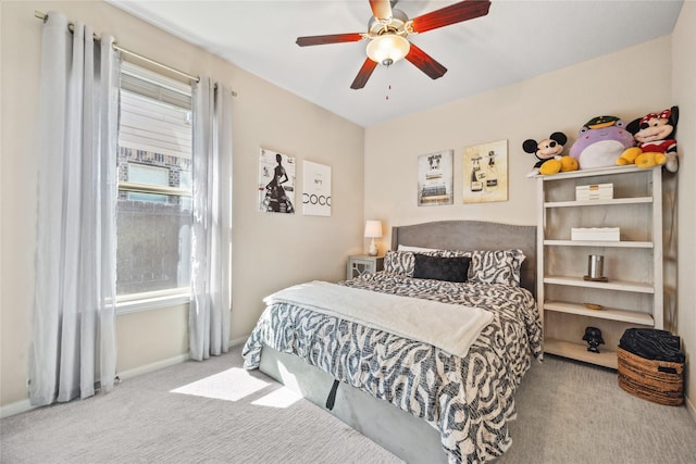 carpeted bedroom featuring ceiling fan and baseboards