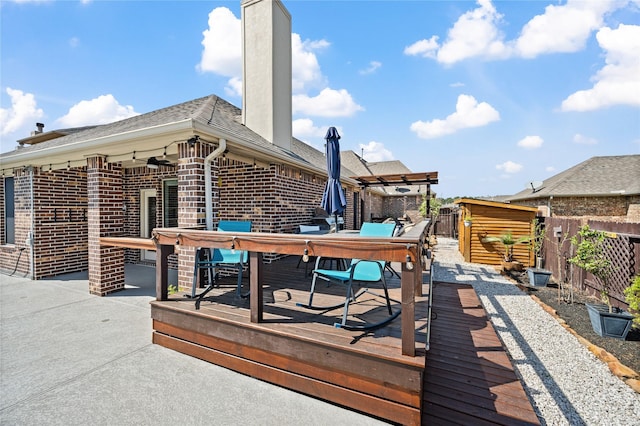 wooden deck with outdoor dining space and fence