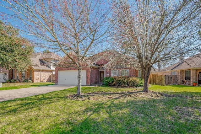 view of front facade with a front yard, fence, driveway, an attached garage, and brick siding