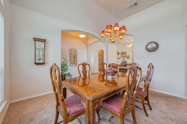 dining area featuring arched walkways, visible vents, light colored carpet, and an inviting chandelier