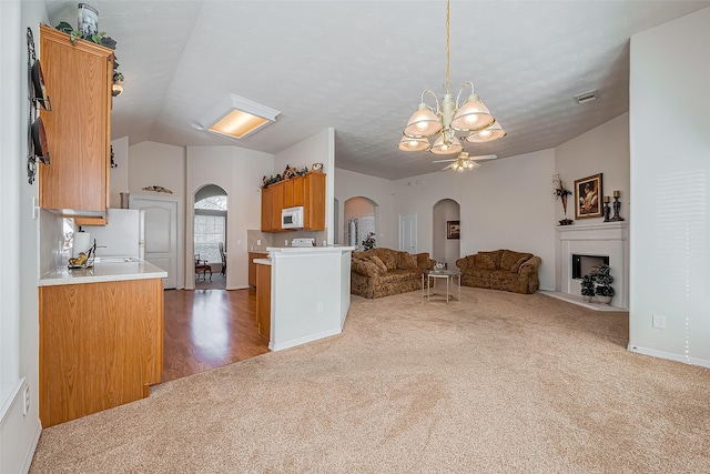 unfurnished living room with visible vents, arched walkways, carpet, and a fireplace