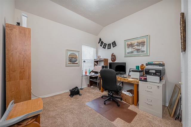 carpeted home office with baseboards and lofted ceiling