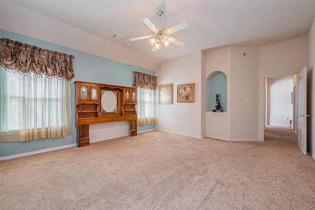 unfurnished bedroom with arched walkways, visible vents, carpet floors, and baseboards