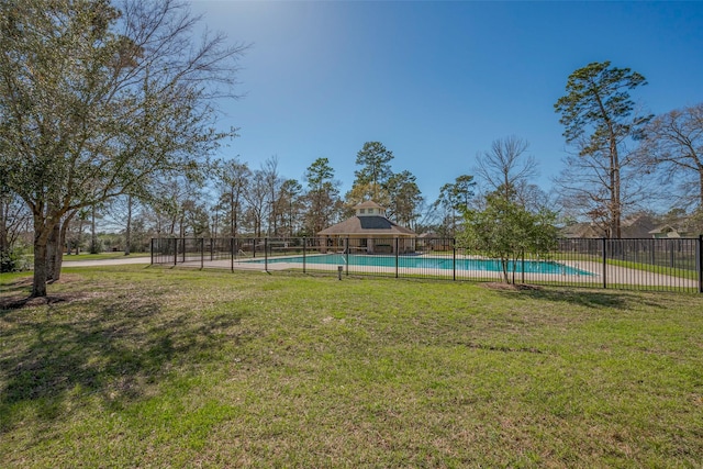 view of yard with a fenced in pool and fence