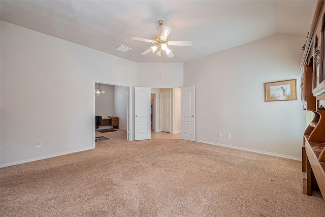 unfurnished bedroom featuring visible vents, light carpet, a ceiling fan, baseboards, and vaulted ceiling