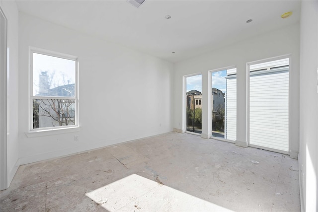 unfurnished room featuring visible vents and baseboards