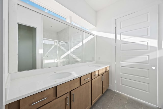 bathroom with a sink, a stall shower, and double vanity