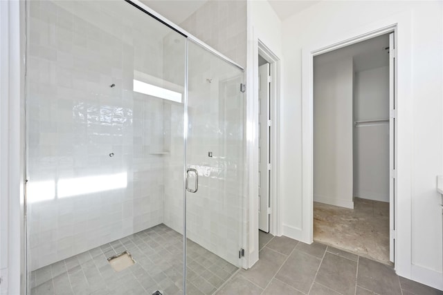 bathroom with tile patterned flooring and a stall shower