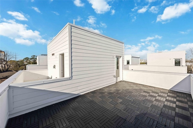 view of side of home featuring a patio area and a balcony