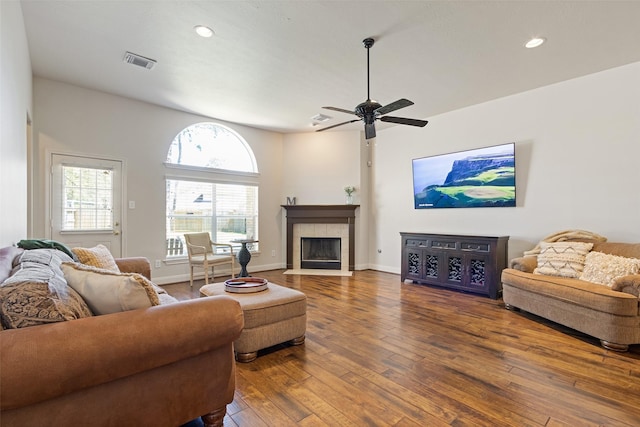 living area featuring visible vents, ceiling fan, recessed lighting, a tile fireplace, and wood-type flooring