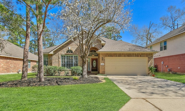 view of front of home featuring a front lawn, brick siding, a garage, and driveway