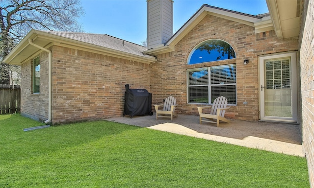 view of patio featuring grilling area and fence