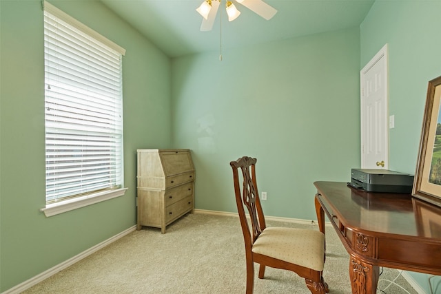 office area featuring ceiling fan, baseboards, and light carpet