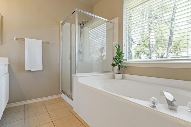 bathroom with tile patterned flooring, a bath, and a stall shower