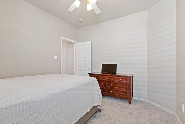 bedroom with light colored carpet, baseboards, and ceiling fan